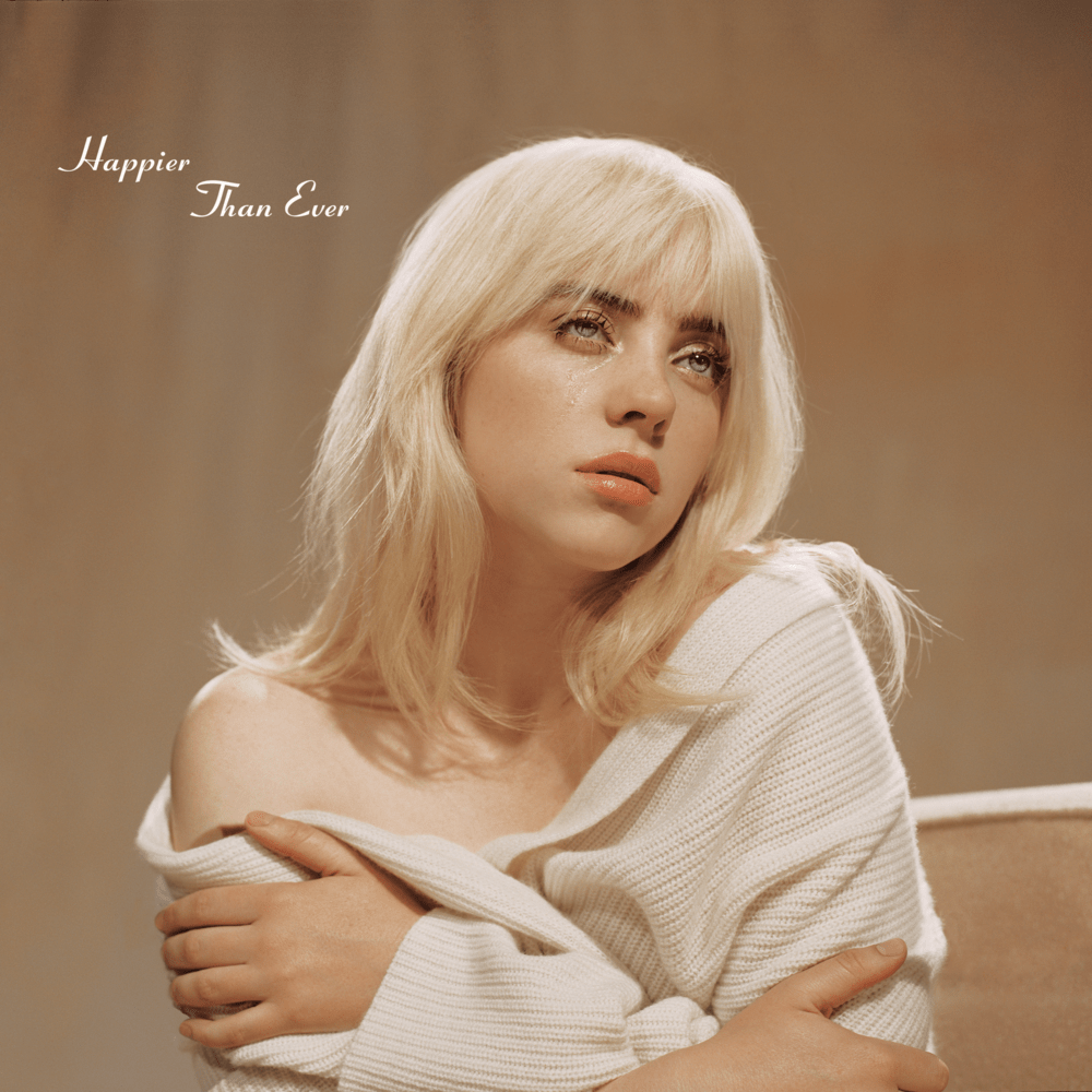 Foto da capa do abum Happier Then ever, cujo novo hit Lost Cause faz parte, da cantora Billie Eilish onde ela aparece vestindo um casado de crochêt branco, mostrando parte dos seus ombros de forma bastante sexual. O fundo da imagem é em tons pastéis. Seus olhos estão voltados para o além e a loira deixou bastante destacado seus lindos lábios.
